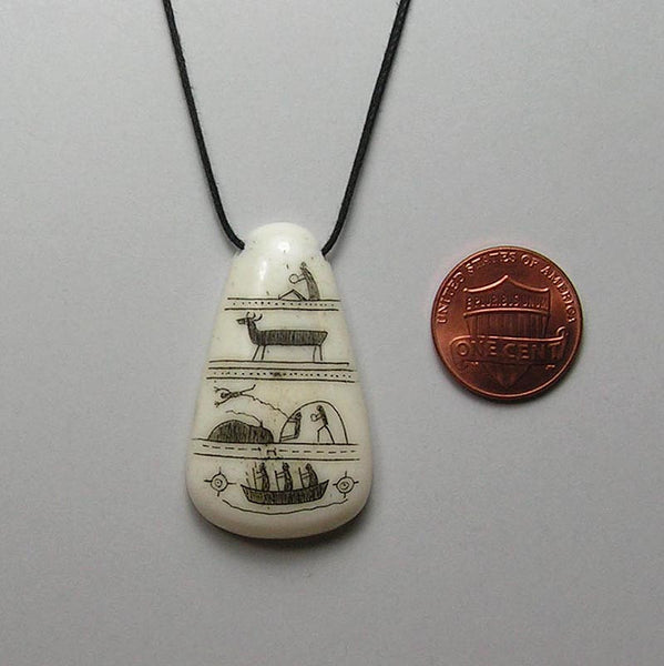 scrimshawed bone pendant